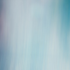 Fototapeta premium Soft blue abstract background with vertical motion blur texture