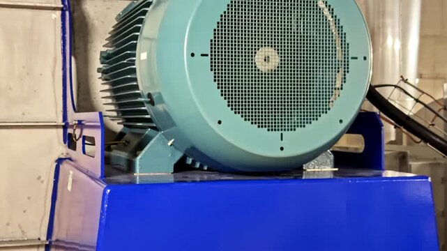 Close-up Of Industrial Electric Motor Mounted On Blue Base.