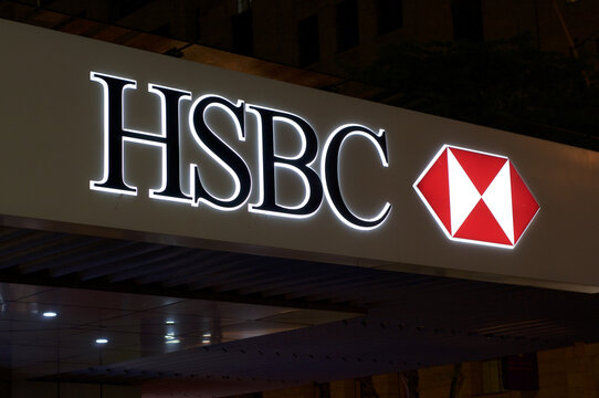 Illuminated HSBC Bank sign on building entrance in Brisbane