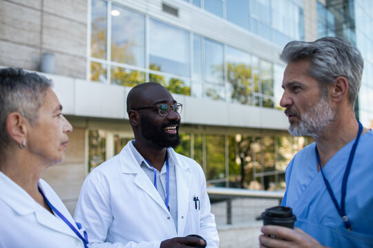 Doctors discussing patient care outside hospital