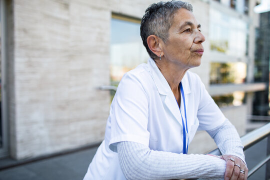 Senior healthcare worker taking a break outside hospital