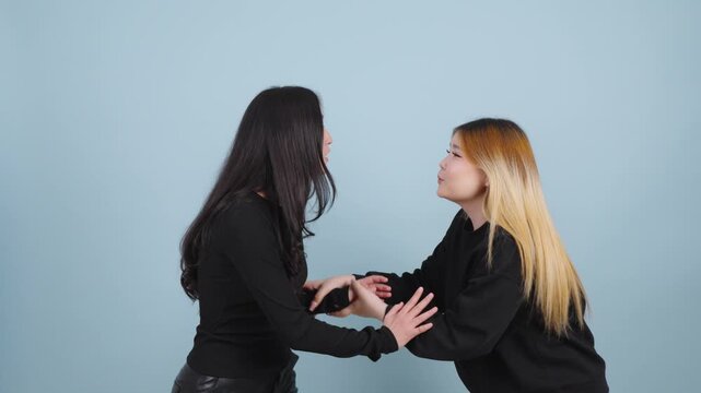 Young woman begging for forgiveness from her annoyed friend
