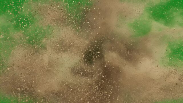 A dynamic explosion of brown powder particles gracefully disperses against a vibrant green screen background, creating a visually striking effect.