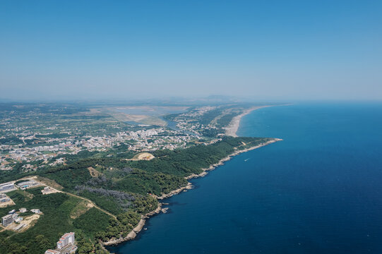 Expansive coast with open waters. Endless shoreline blending into distant ocean
