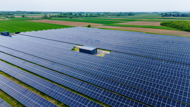 Aerial view of a large solar panel farm surrounded by green agricultural fields and rural landscape Sabac, Vojvodina, Serbia.