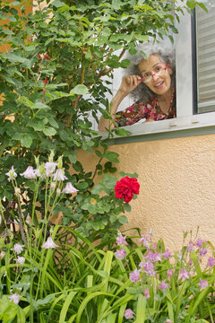 Curious elderly smiling neighbor