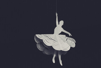 White paper cut out ballerina silhouette hanging on a thread against dark background © Artem