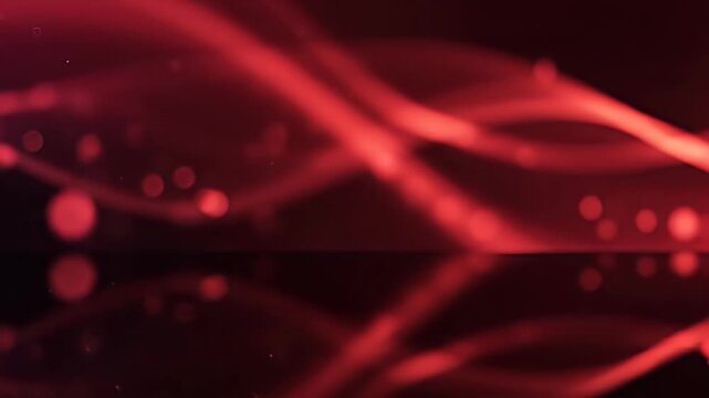 An abstract image showcases flowing red and dark red ribbons against a blurred dark background, creating a dynamic and visually striking composition.
