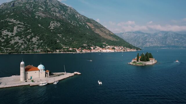 Peaceful island chapel with mountain background. Serene aerial image of island chapel and tranquil bay scene