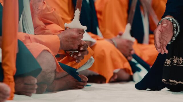 Indian guards in orange robes guard the sacred text of the Sikh during Vaisakhi