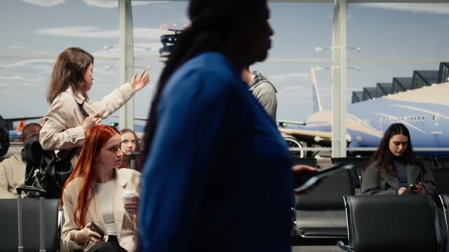 Scolding man, bumping trolley and upset woman in airport hurrying to catch plane. Yelling, bashing luggage and angry tourist with traveler in busy departure terminal, camera A