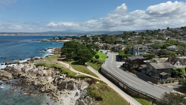 Pacific Grove, California, USA - Cinematic Aerial Drone View of Oceanfront Homes, Coastal Road and Rocky Monterey Bay Shoreline