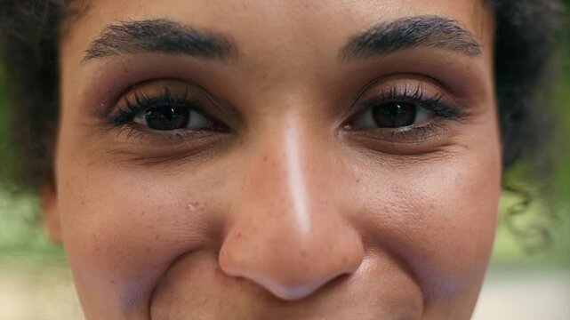 Happy African American woman close up portrait smiling city outdoors cropped view female girl eyes vision eyesight laser correction health medicine looking at camera face positive confident lifestyle