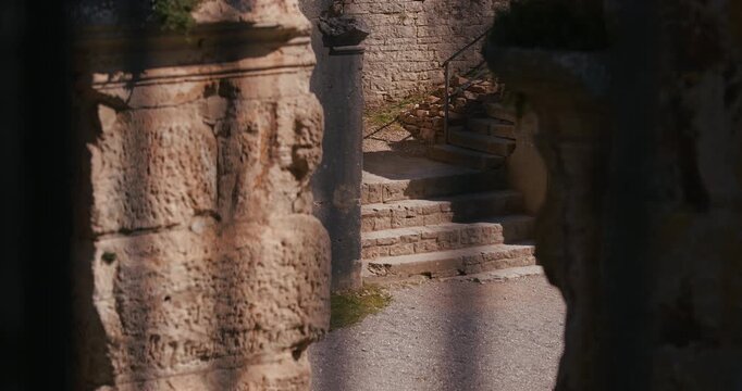 View of a stone staircase inside the ancient Pula Arena Roman amphitheater framed by weathered stone walls in Pula Croatia.