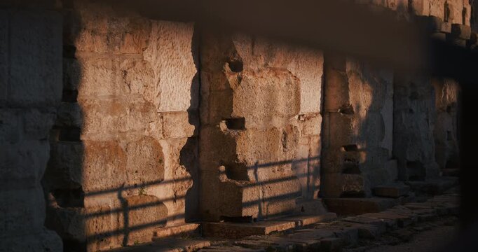 Close view of a weathered stone wall and textured architectural detail on the exterior of the ancient Pula Arena Roman amphitheater in Pula Croatia.
