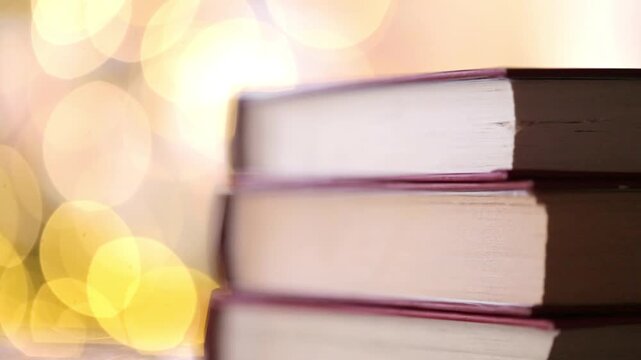 book pages and Soft yellow bokeh. Cozy Bookish Mood.Cozy reading. Book blog wallpaper. 4k footage