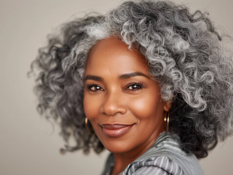 Confident mature African American woman with natural gray curly hair