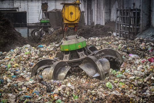 View of mechanical grapples moving organic waste at the Forsu Iren treatment plant in Reggio nell'Emilia, Emilia-Romagna, Italy.