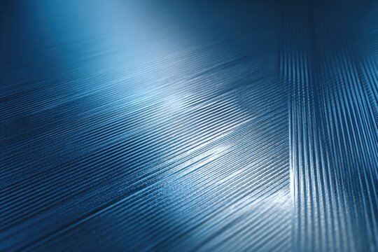 A metallic blue background with brushed texture and geometric embossing, reflecting subtle light for a sleek industrial look.