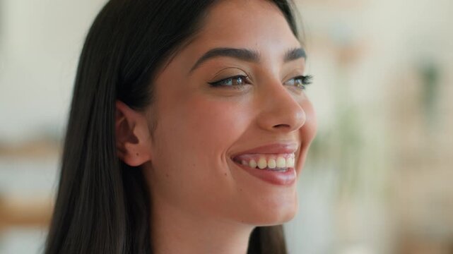 Joyful funny Indian woman at home looking at camera showing tongue playing flirt happy excited success achievement cheerful Arabian girl Latina female positive emotion playful mocking face indoors