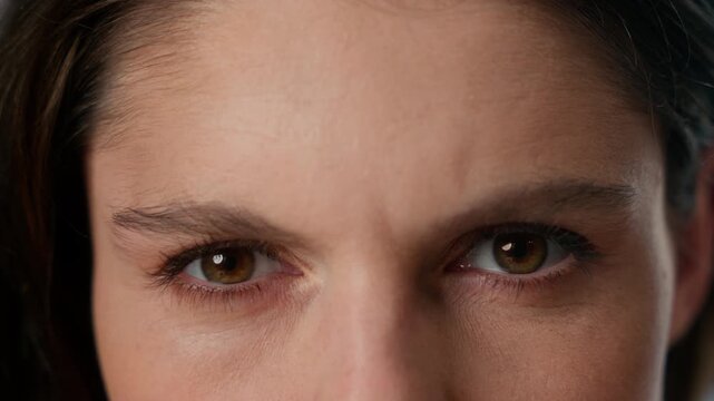 Extreme close up Caucasian angry mad woman eyes looking at camera staring annoyed female gaze eye vision eyesight skin wrinkles detail girl student businesswoman health medical problem agressive sight