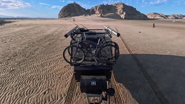 A teardrop camper trailer is towed across the sand at Gonzaga Bay in Baja California, Mexico during a beach camping trip.
