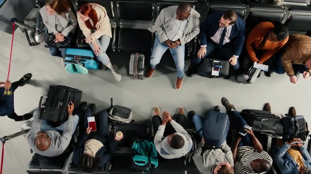 Giving flight announcement, stanchion and top down shot of gate agent in airport with tourists. Inviting people to queue up for boarding gate, crowd control and airline worker