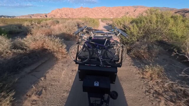 Towing a teardrop camper trailer along the sandy path in Gonzaga Bay with bikes on top, perfect for exploring the area.