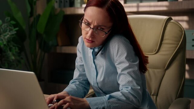 Busy Caucasian business woman multitasking writing notes talking phone work laptop inside office anxious businesswoman female entrepreneur manage tasks online deadline pressure planner consulting call