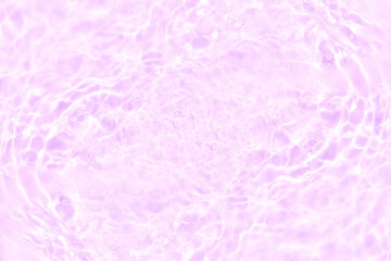 Fototapeta premium Pink water bubbles on the surface ripples. Defocus blurred transparent pink colored clear calm water surface texture with splash and bubbles. Water waves with shining pattern texture background