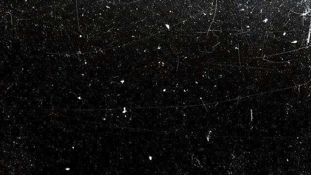 Black background with white scratches and specks