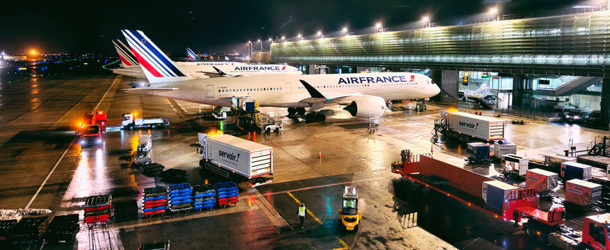 Paris,France-Nov.24th 2025: Air France airplanes and ground handling operations on the tarmac of Paris Charles de Gaulle Airport at night