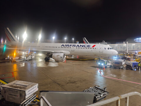 Paris,France-Nov.24th 2025: Air France airplane and ground support equipment on the tarmac of Paris Charles de Gaulle Airport at night