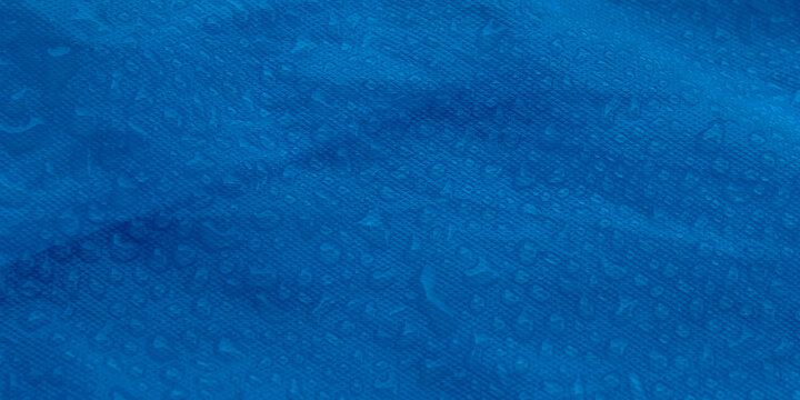 Water Droplets on Blue Waterproof Synthetic Fabric Surface