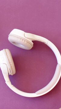 Vertical video: Resting white headset sitting on purple mat, camera shifting showing buttons