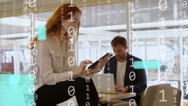 Woman tapping tablet, causing teal binary overlay as man typing laptop, visualizing tech data flow