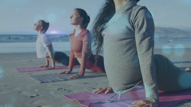 Three women practicing backbend on beach mats, inhale deepening pose for health, bokeh drifting