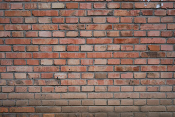 Obraz premium Close up view of weathered red brick wall texture
