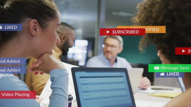 Two women reacting to animated social alerts cascading over laptop in business, then refocusing