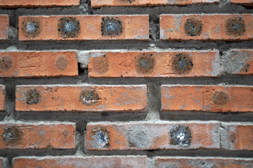 Fototapeta premium Close up view of aged weathered red brick wall texture