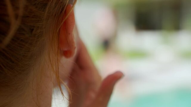 Woman with hand to her mouth talking and gossiping