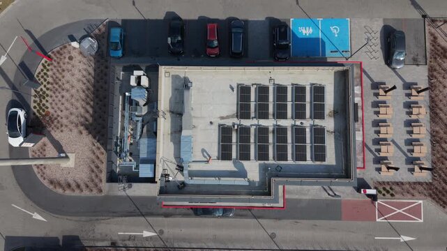 Birdseye Rooftop Solar Panel Layout Showcasing Compact Module Rows, Adjacent Parking Bays, Accessible Blue Bay, Outdoor Dining, Curb Landscaping, Midday Clarity, Community Energy Narrative,