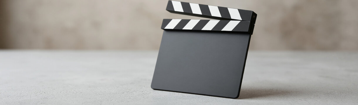 Clapperboard on set: A classic clapperboard sits, poised for action, on the set. Featuring a simple yet symbolic tool, representing the heart of film production.