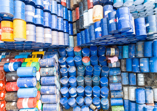 Aerial view of hundreds of colorful industrial metal barrels stacked in organized rows at a storage facility in Dhaka, Dhaka Division, Bangladesh.