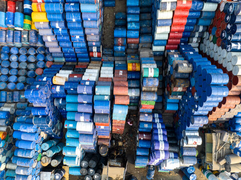 Aerial view of thousands of colorful metal barrels stacked in rows at an industrial storage facility in Dhaka, Dhaka Division, Bangladesh.