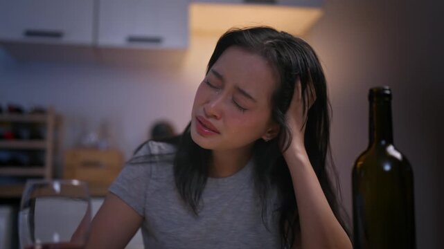 Asian young depression woman feeling heart broken and drinking wine.