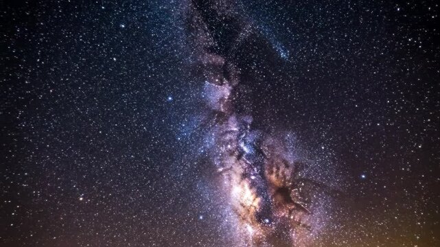 A stunning long-exposure photograph captures the vibrant Milky Way galaxy streaked with a bright shooting star across a dark, expansive night sky.