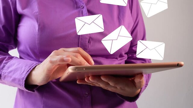Close-up of a businesswoman interacting with her tablet with an animation of several mail envelopes rising. Arrival of several emails.