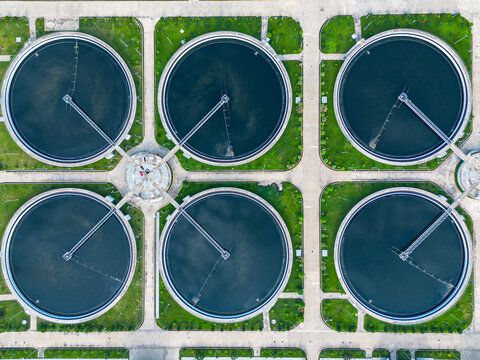 Aerial view of the circular clarifier tanks at the Sewage Treatment Plant, Dhaka WASA, surrounded by green lawns and concrete paths in Dhaka, Dhaka Division, Bangladesh.