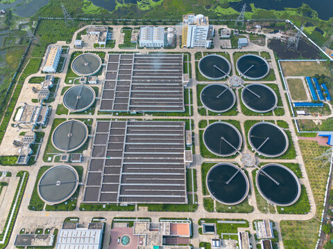 Aerial view of the Sewage Treatment Plant, Dhaka WASA featuring circular sedimentation tanks and rectangular basins surrounded by greenery in Dhaka, Dhaka Division, Bangladesh.